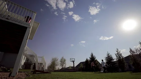 Time-lapse of two men playing bags at a cookout in the Afternoon Stock-Footage 144899108