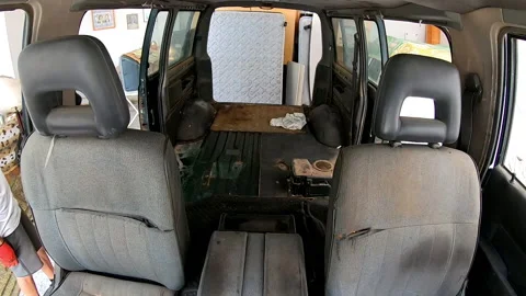 Time lapse two people removing panels from the floor of a camper van Stock Footage 172081433