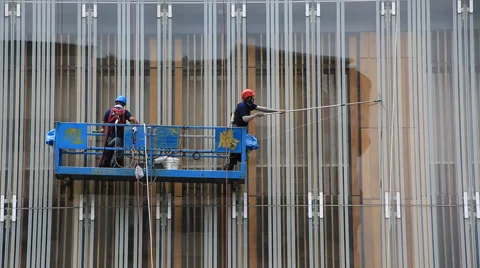 Time lapse of two washers washing windows of the building in Taipei downtown Stock Footage 63138350