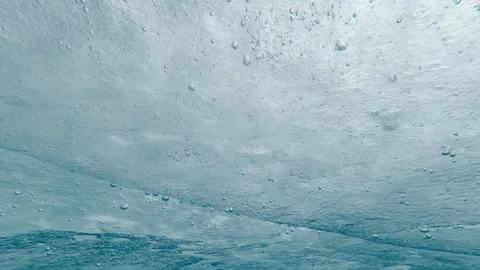Time lapse, Underwater view of thin spring loose ice with air bubbles on ocean Stock Footage 339372889