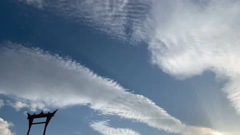 Time lapse of unusual, undulating cloud formation with Asian icon Stock Footage 137715623