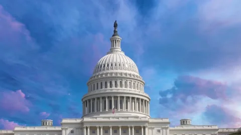 Time lapse of the US Capitol set against a blue sky with layers Stock Footage 175818247