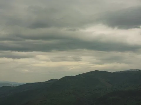 Time-lapse of a valley with clouds and an approaching storm Stock Footage 281799410