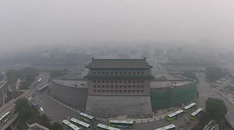 Time Lapse of vehicles driving around a watchtower amid the heavy haze Stock Footage 42497408