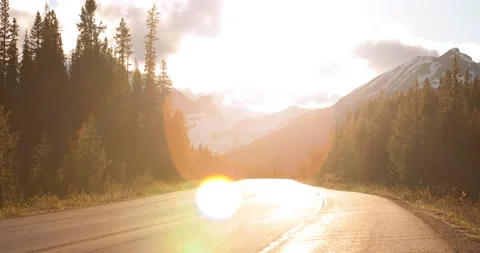 Time Lapse Vehicles Moving On Road Amidst Forest By Snowy Mountains Against Stock Footage 160319930