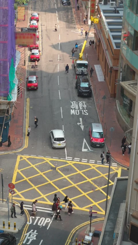 Time lapse - Vertical Hong Kong, China March 31, 2025 Red Taxis in the Streets Stock Footage 306575385