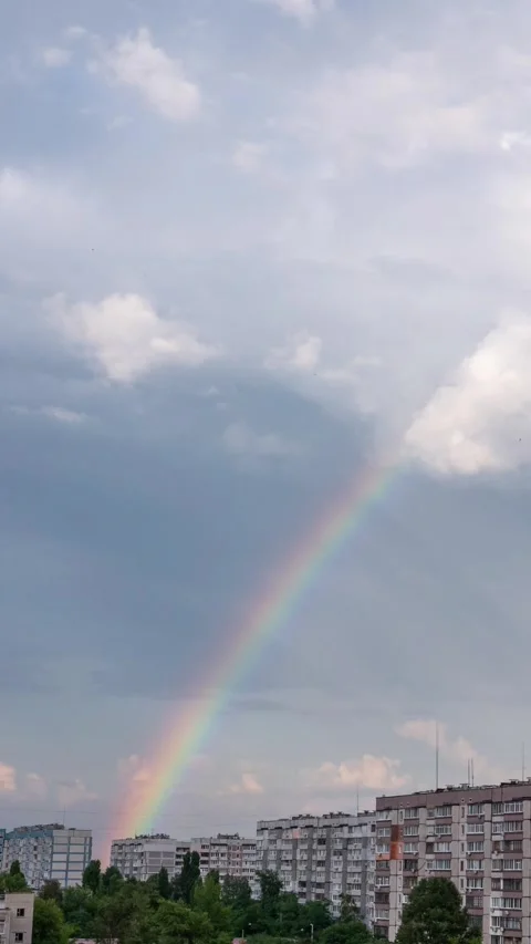 Time Lapse of Vibrant Rainbow Appearing Over Urban Apartment Buildings Stock Footage 342003032