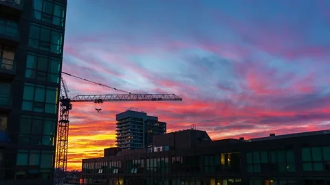 Time lapse of a vibrant sunset behind apartment buildings and condominiums. Stock Footage 152717586