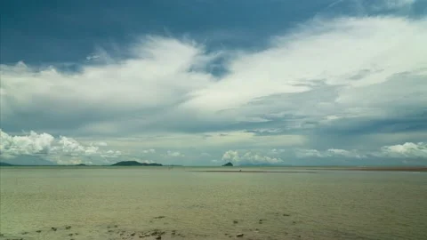 Time lapse video of beautiful beach water front and clouds on sunny day. Stock Footage 196985895