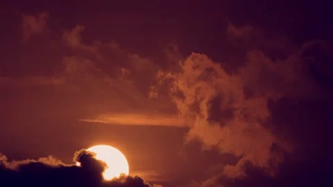 Time-lapse video of the big sun rising through clouds. Stock Footage 257056784