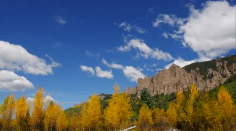 Time lapse video of clouds, mountains and big blue skies on a crisp autumn day. Stock Footage 55495412