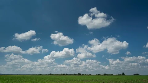 Time lapse video of clouds over green field Stock Footage 114666299