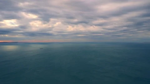 Time lapse video of cloudy sky moving fast over the sea with strong wind Stock Footage 99642411