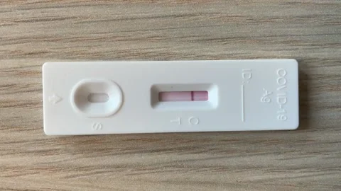 Time-lapse video of a Covid-19 tester on the wooden table displaying negative Stock Footage 170480692