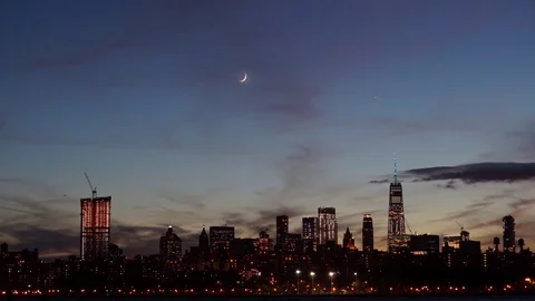 Time-lapse video of the Crescent Moon Setting next to the World Trade Center Stock Footage 80377372