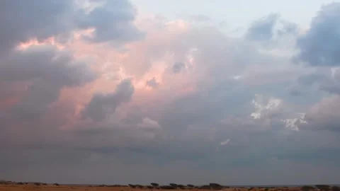 A time lapse video of a dramatic sunset sky with vibrant clouds over the landsca Stock Footage 318646094
