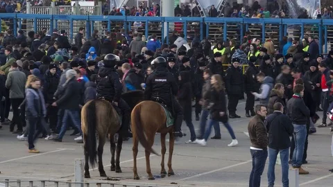 Time lapse video of the flow of fans and mounted police before the football.. Stock Footage 73597863