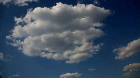 Time-lapse video of fluffy white clouds floating in a blue sky Stock Footage 341458927