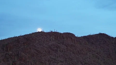 Time-lapse video of the Full Moon Rising above The Tucson Mountains in Arizona Stock Footage 84326019