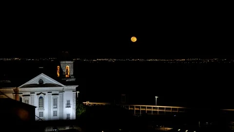 Time lapse video of full moon rising over night Lisbon city, Portugal Stock Footage 105656163