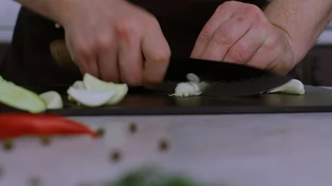 Time-lapse video of garlic on a cutting board. Deftly, the cook finely chops the Видео 269161901