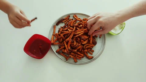 Time lapse video of hands taking sweet potatoes fries. Funny end Stock Footage 140675896