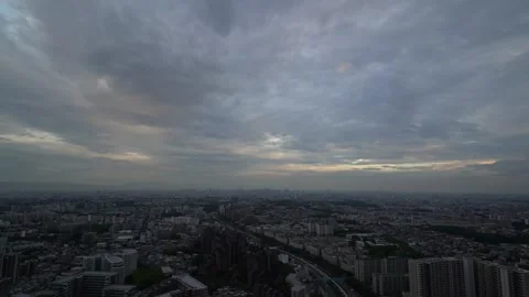 A time-lapse video of a heavy cloudy sunset day over Osaka city Stock Footage