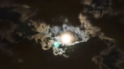 Time lapse video of the moon coming through the clouds Stock Footage 76503305