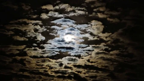 Time lapse video of the moon coming through the clouds Stock Footage 78563808