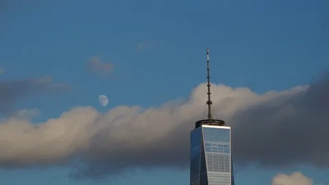 Time-lapse video of the moon rising before sunset next to the World Trade Center Stock Footage 71129650