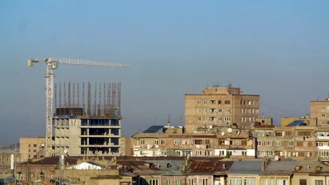 Time Lapse video. A moving crane works above an unfinished building. Stock Footage 297603928