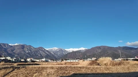 Time-lapse video of Mt. Kiso-Komagatake taken from a rice field in Komagane City Stock-Footage 299664139