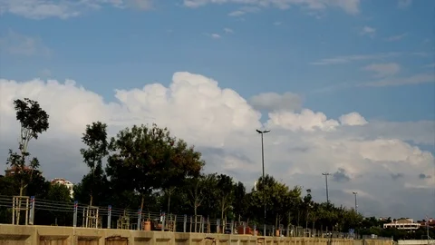 Time lapse video of people walking on the park and clouds passing Stock Footage 82186732