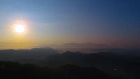 Time-Lapse Video - The Sun Rises Over The Mountains And Clouds On a Foggy Day Stock Footage 170154642