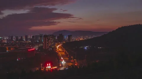 Time lapse video of sunset sky with buildings and road traffic vehicles at dusk  Stock Footage 160877201