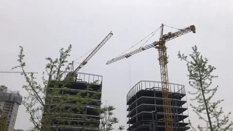 Time lapse video, two crane in construction site lift materials in Shanghai Stock Footage 131076483