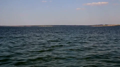 Time-lapse video of a variety clouds floating in the blue sky above the estuary Stock Footage 341459103