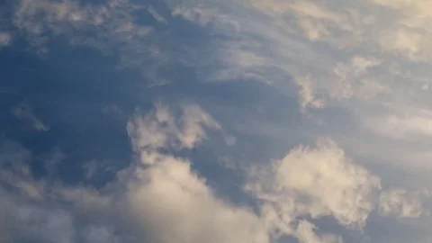Time lapse video of white cumulus and fleecy clouds morphing on blue sky, 4K Stock Footage 76379971