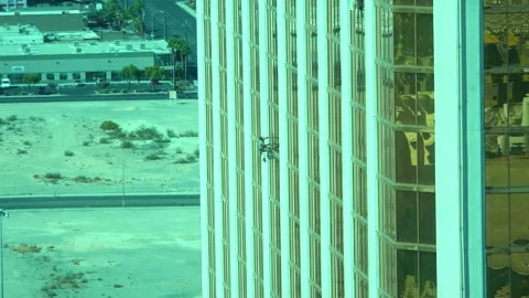 Time lapse video of window washers cleaning a tall glass skyscraper with a .. Stock Footage 281276695