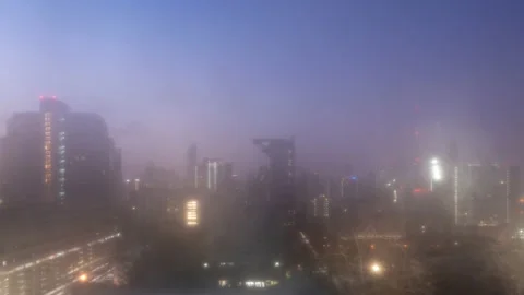 Time lapse view of Bangkok high-rises  during dawn with heavy fog Stock Footage 230912703