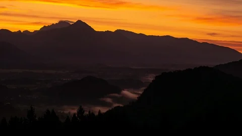 Time-lapse view on the beautiful sunrise over the majestic hills with the Lake Stock Footage 117542292