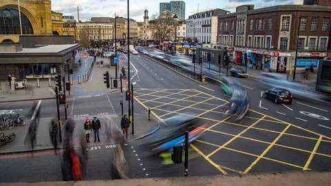 Time lapse view of a busy crossroad by King's Cross station in London Stock Footage 86477660