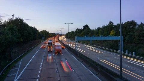 Time lapse view of a busy expressway with light trails during a sunset. 스톡 동영상 107982415
