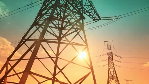 Time lapse view of clouds hovering over an electrical tower at sunrise. Stock Footage 211410358