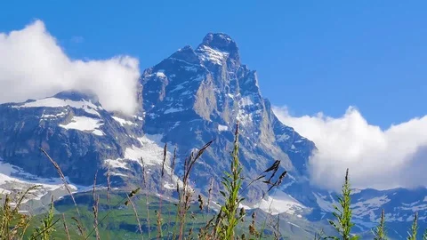 Time lapse view clouds Matterhorn Matterhorn French Swiss Alps Zermatt blue sky Stock Footage 124231848