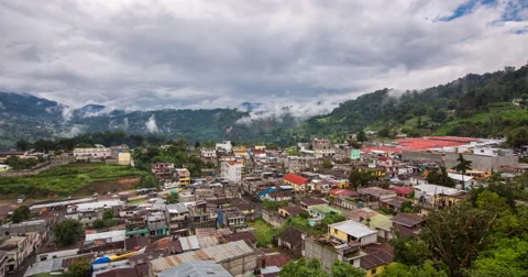 Time Lapse of view of clouds moving over townscape, Guatemala City Stock Footage
