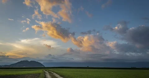 Time lapse view of clouds moving over farming field meadow Stock Footage 136900152