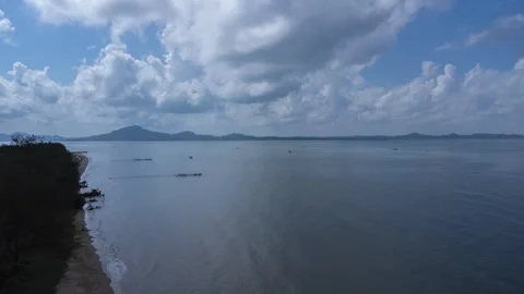 Time lapse view of the coastline with clouds and mountains in the backgroun.. Stock Footage 275678313
