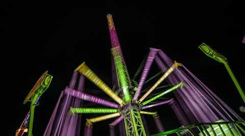 Time Lapse view of a colorful fun fair attraction at night 動画素材 21303011