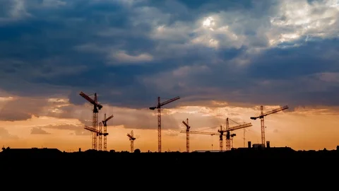 Time-lapse view on a consturction site with cranes during sunset Stock Footage 113776193